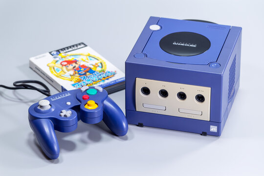 Fukuoka, Japan. June 6, 2026: Nintendo GameCube console with blue controller and Super Mario Sunshine game case photographed as a retro gaming product setup.