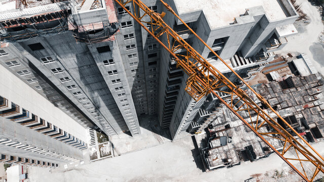 Top Down View Of Tower Crane Over High Rise Building Under Construction