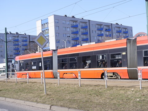 Katowice, Poland - March 9, 2026. An orange tramway in motion in a Polish city. 
