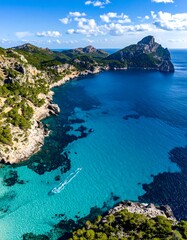 Fototapeta premium Aerial view of a turquoise bay, cliffs, and the sparkling sea