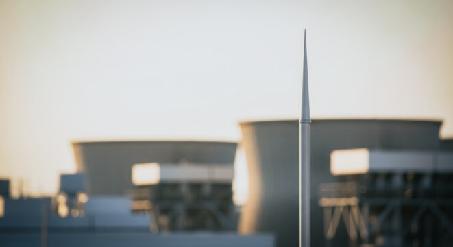 Lightning rod on an industrial roof with cooling towers in the background