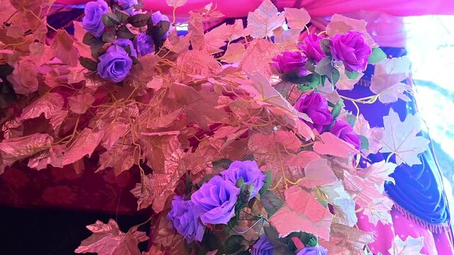 Floral Wedding Backdrop with Decorative Garlands and Roses, Colorful floral decorations and marigold garlands arranged for an Indian wedding ceremony. The decorative wedding backdrop