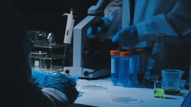 A laboratory technician makes microscopic bacteriological examination with the reagents. Work in microlaboratories