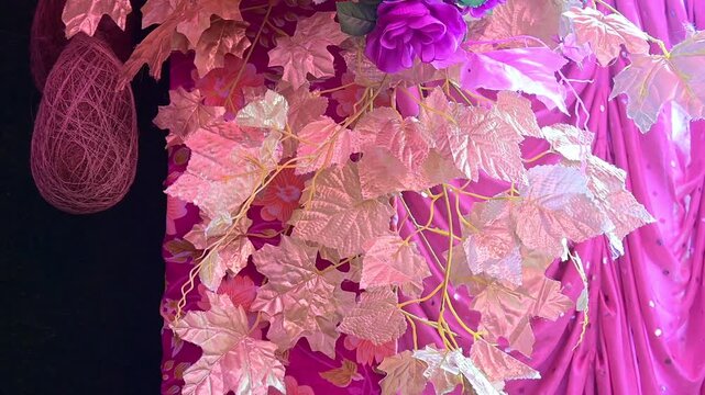 Luxury Wedding Venue Decoration with Colorful Flower Arrangements, The decorative wedding backdrop features flowers, lights, floral arches, and festive stage elements used during marriage celebrations