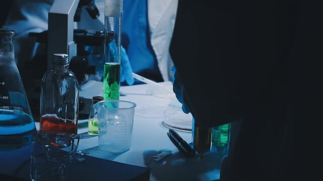 A laboratory technician makes microscopic bacteriological examination with the reagents. Work in microlaboratories