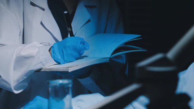 A laboratory technician makes microscopic bacteriological examination with the reagents. Work in microlaboratories