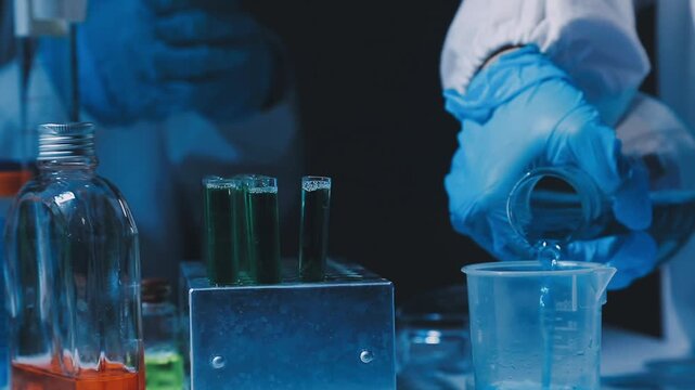 A laboratory technician makes microscopic bacteriological examination with the reagents. Work in microlaboratories