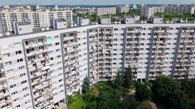 residential apartment block building estate panel development suburb housing market. Aerial drone view. This high-angle perspective showcases a large, modernized panel block complex representing typic