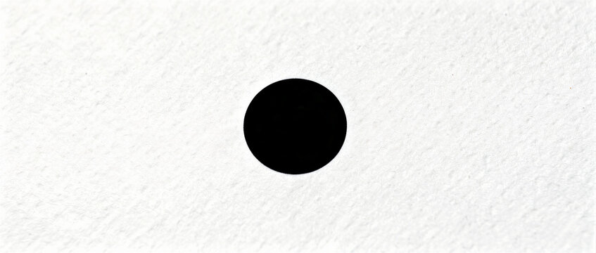 Single black circle centered on white textured paper. Minimalist graphic element featuring a round dot on a rough surface. Abstract concept ideal for focal points and modern design layouts.