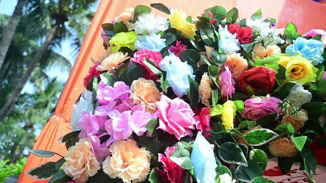 Luxury Wedding Venue Decoration with Colorful Flower Arrangements, The decorative wedding backdrop features flowers, lights, floral arches, and festive stage elements used during marriage celebrations