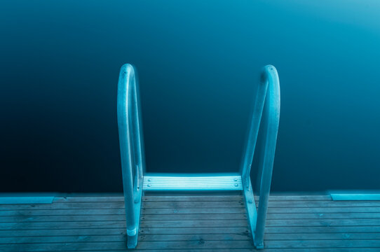 Stair leading to a lake in Sweden with a focus on the water and surrounding calmness