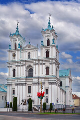 Fototapeta premium St. Francis Xavier Cathedral in Grodno, Belarus front facade. Partly cloudy day, historic baroque architecture landmark