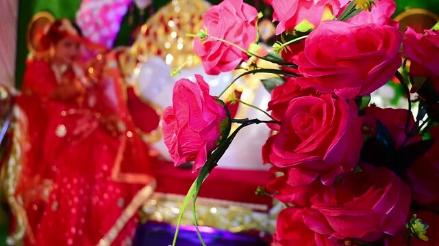 Beautiful wedding decoration featuring colorful artificial and fresh flowers, marigold garlands, floral arches, decorative lights, wedding backdrop elements, and festive stage arrangements.