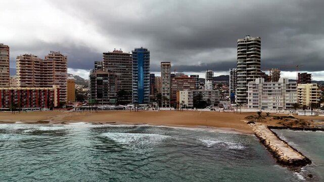 Low aerial drone pan of Calpe beach and coastline, Costa Blanca, Spain