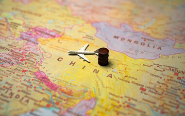 Obraz premium Toy plane and oil barrel on China map.