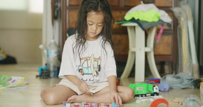 Little school boy and girl enjoy play car toy building in cozy room education concept