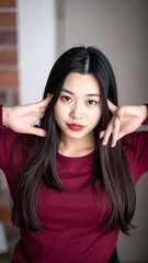 Naklejka premium Young Asian woman with long dark hair.