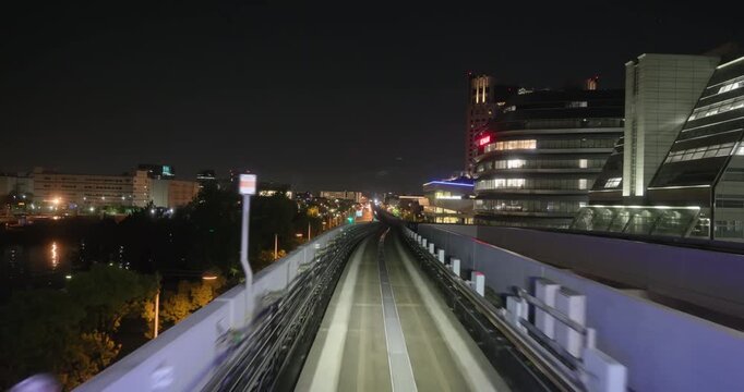 Train goes through city at night,  concept of speed, time lapse