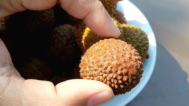Close up of sweet honey lychees in a wooden bowl for commercial design