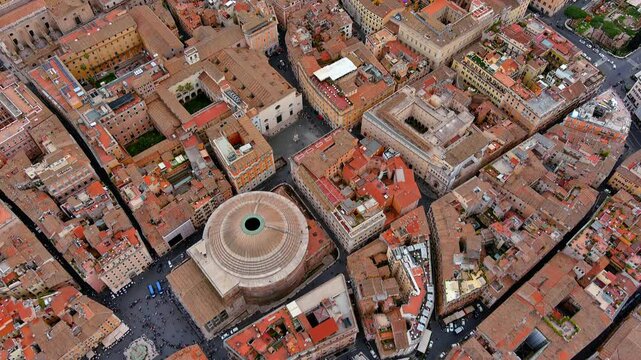 4K aerial drone tilt-up starting nadir above the Pantheon and Piazza della Rotonda, Rome sweeping reveal of terracotta rooftops and historic centre, Italy.