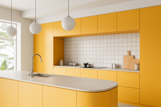 Bright modern yellow kitchen interior with minimalist cabinetry, tiled backsplash, sleek island counter and spherical pendant lighting in a contemporary space. 3D Rendering