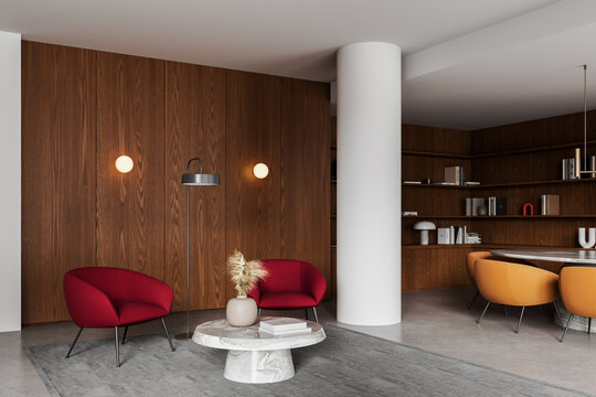 Modern interior lounge with red chairs, marble table, wood panel walls, column, shelving, and cozy seating arrangement in elegant contemporary design. 3D Rendering