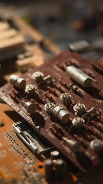 Analyzing Capacitor Setup Under Light. Technician Reviews Wiring And Capacitor Arrangement Meticulously. Media