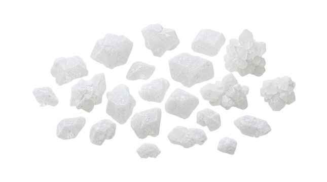Group of coarse white sea salt crystals scattered on a pure isolated white background