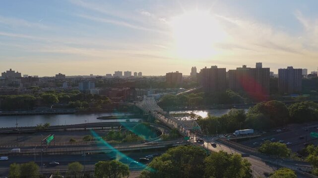 Urban infrastructure in South Bronx with Bruckner Expressway traffic and Willis Avenue Bridge crossing Harlem River at sunset, capturing daily city life in New York