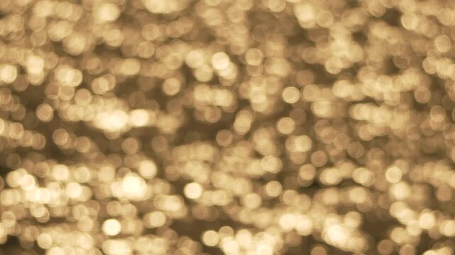 Bokeh glitter light shimmering over water surface in golden sunlight creating a warm and dreamy atmosphere