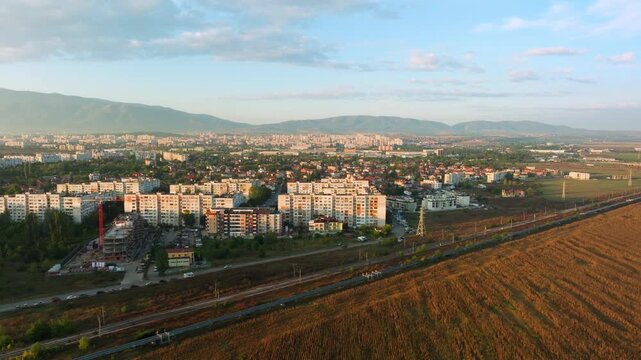 Aerial approach of Sofia's district Obelya from the city outskirts during sunrise