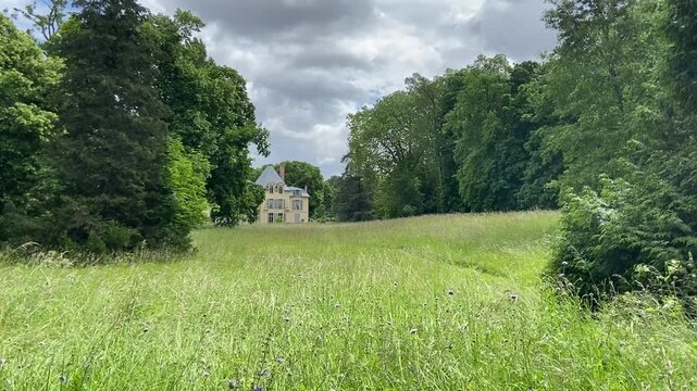 Ch&acirc;teau de malmaison appearing through lush green trees