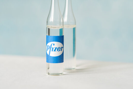 Glass bottle with logo Pfizer, American multinational pharmaceutical company.
