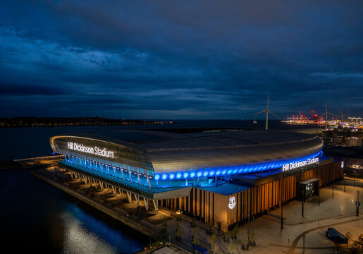 Hill Dickinson Stadium in Liverpool, Merseyside, England at night. Modern football stadium illuminated after dark on the River Mersey waterfront, aerial view of a major sporting landmark.
