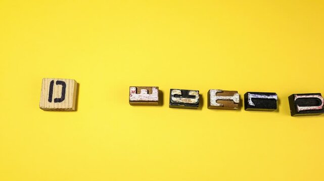 Decluttering Concept Shown With Vintage Letterpress Blocks on Yellow Background