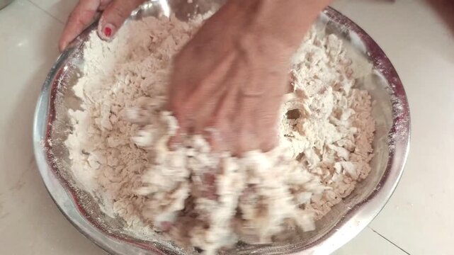 Indian Woman Kneading Wheat Flour Dough in a Steel Bowl for Making Roti, Close-up
