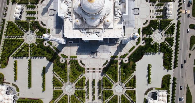 Top down aerial view of the majestic white marble Pride of Muslims mosque domes and symmetric park architecture in Shali, Chechnya