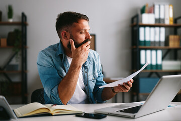 Man worrying about financial problems and paperwork