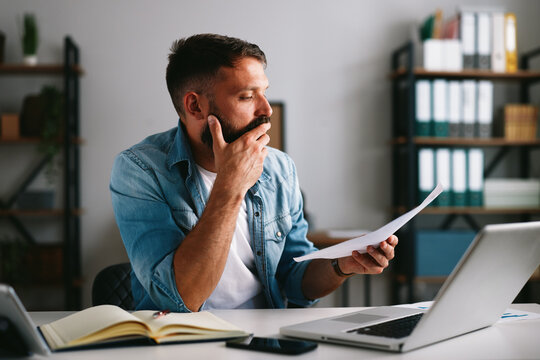 Man worrying about financial problems and paperwork