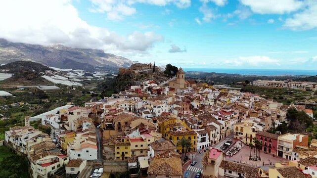 Aerial drone approach to church and castle, Polop town, Costa Blanca, Spain