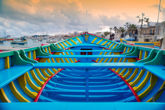 Colorful wooden boat interior at a harbor during sunrise