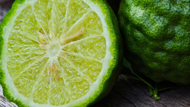 Fresh kaffir lime fruit on a wooden floor.