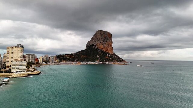 Drone flight over ocean towards Penon de Ifach rock, Calpe, Spain
