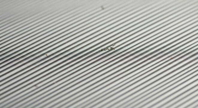 Macro Metal Surface with Precise Parallel Grooves and Small Debris Particles