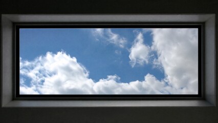 Fototapeta premium Rectangular sunroof framing moving clouds against a blue sky, minimalist architectural detail.