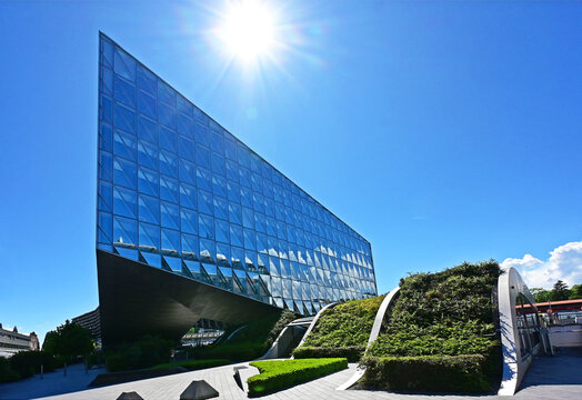 Geneva, Switzerland, Europe :  05.2026 :  Japan International Tobacco (JIT) - futuristic headquarters building with characteristc self-shading glass facade