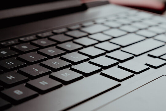 Close-up view of a sleek black laptop keyboard showcasing modern technology and design, ideal for tech enthusiasts and digital workspace visuals.