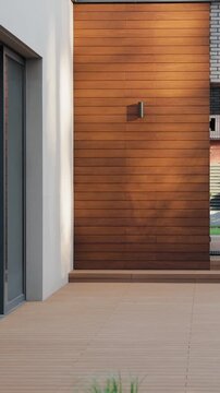 Vertical video. Modern residential building entrance with timber wall cladding and green plant.