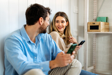 Fototapeta premium Digital lifestyle, online connectivity. Diverse couple enjoying entertainment shopping with laptop