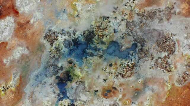 Abstract Earth Texture of a Geothermal Area with Colorful Mineral Deposits and Steaming Pools